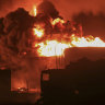 Oil tanks burn at the port in Hodeidah, Yemen on Sunday.