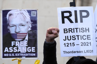 Julian Assange supporters protest in front of the High Court in London on Friday.
