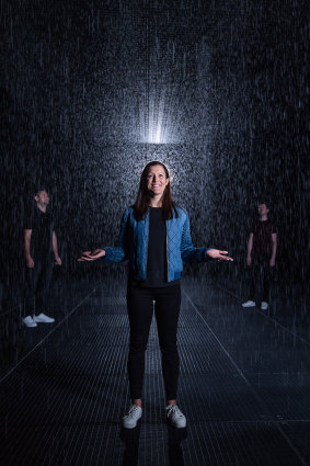 From left: Josh Green, Bianca Collie and 
Dirk Strachan inside Melbourne's Rain Room.