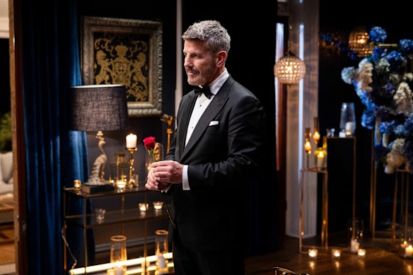 Barry “Bear” Myrden prepares to present a rose in the Golden Bachelor’s first rose ceremony 