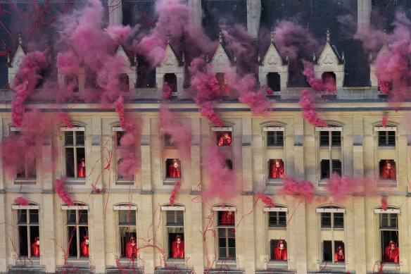 Smoke billows from windows as part of a sequence featuring decapitated Marie Antoinettes.