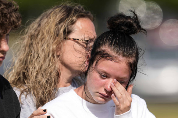 A student weeps at a makeshift memorial after the shooting at Apalachee High School in Winder, Georgia, on Wednesday.