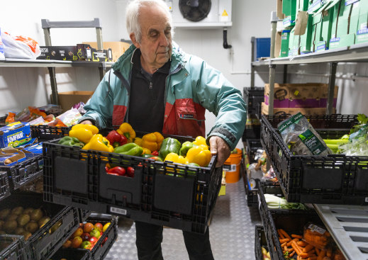 Volunteer Graham Collier with donated food in the pantry cool room.