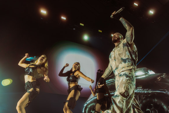 J Balvin, flanked by back-up dancers and a giant inflatable tank at Margaret Court Arena.