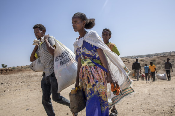 Tigray refugees who fled the conflict in the Ethiopia's Tigray walk to Hamdeyat Transition Center after arriving on the banks of the Tekeze River on the Sudan-Ethiopia border, in Hamdayet, eastern Sudan, Saturday, November 21.