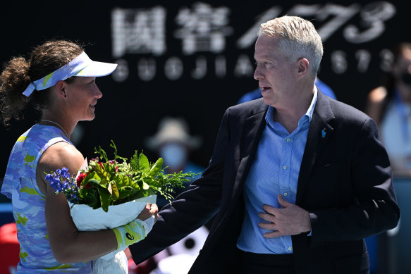 Tennis Australia boss Craig Tiley presents flowers to Sam Stosur after her final Australian Open singles match.