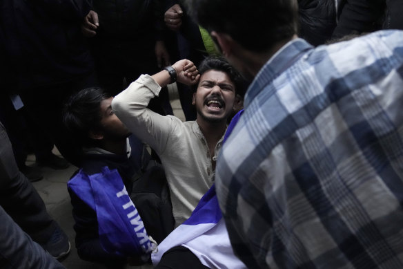 A student resists being escorted out of the campus at Delhi University, after a student group said it planned to screen a banned documentary that examines Indian Prime Minister Narendra Modi’s role during the 2002 anti-Muslim riots.