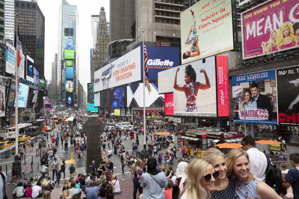 Tourists visit Times Square in pre-pandemic days.