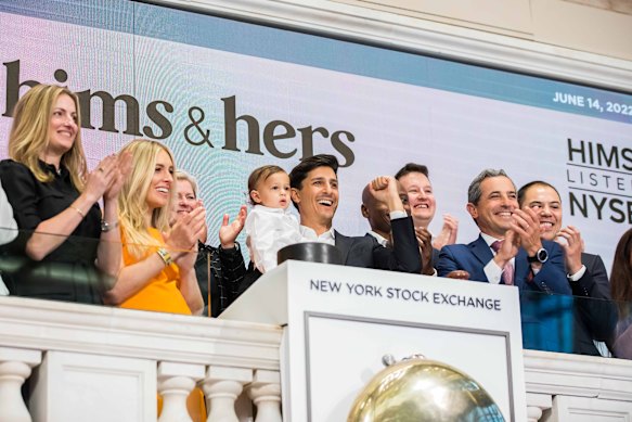 Hims & Hers CEO Andrew Dudum holding his son at the IPO on June 14, 2022. Photo: Supplied.