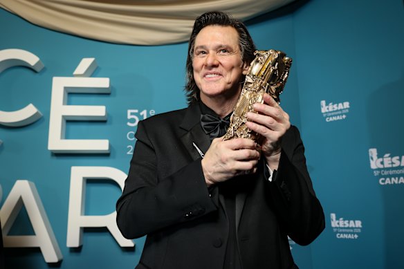 Jim Carrey poses after receiving the César of Honour award during the 51th Cesar Awards ceremony in Paris.