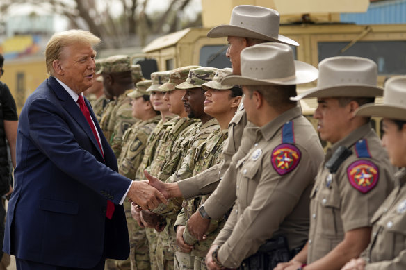 Donald Trump greets members of Texas Department of Public Safety as he visits Shelby Park on the US-Mexico border in February, during the presidential campaign.