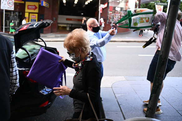 Grimley hits freelance photographer Flavio Brancaleone with his shopping bag.