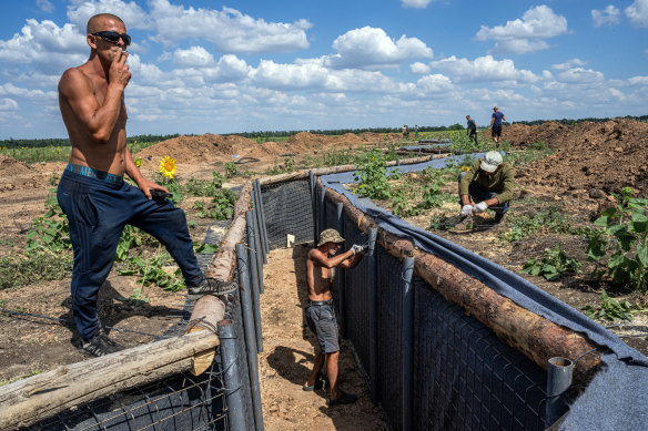 Workers install a trench line in the Donetsk region of eastern Ukraine.