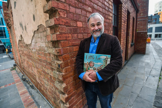 Vanished world: Andrew Kelly with Little Lon, his children's book about living in the CBD in the 1920s. 