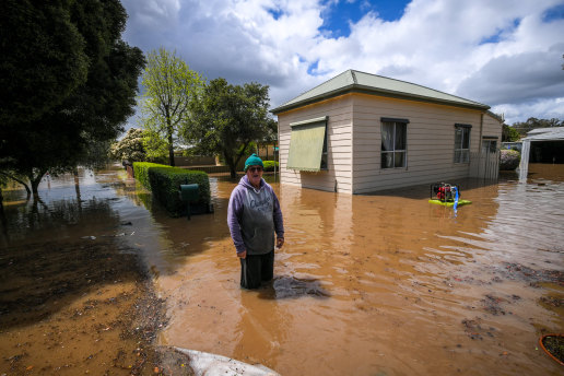 Rochester resident Brian Mulcahy outside his inundated home on Friday.