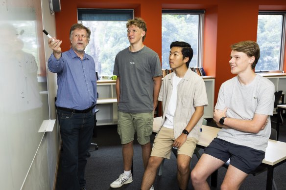 Knox Grammar year 12 students Harry Cumming, Beau Morrison and Ethan  Huang with their HSC maths  teacher Ian Bradford.