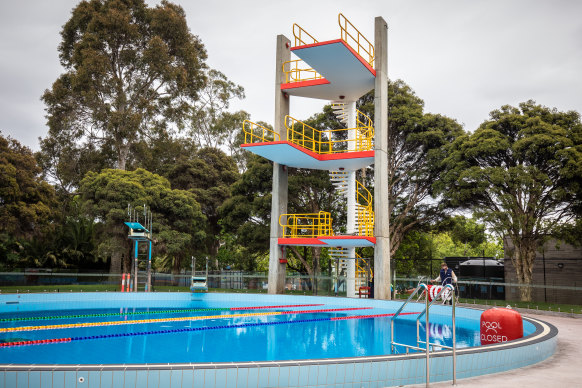 The original and unusable diving tower overshadows new springboards at the restored Harold Holt Swim Centre diving pool.