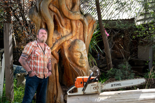 Like a gallery: Artist Leigh Conkie with one of his sculptures in front of his Eltham house.