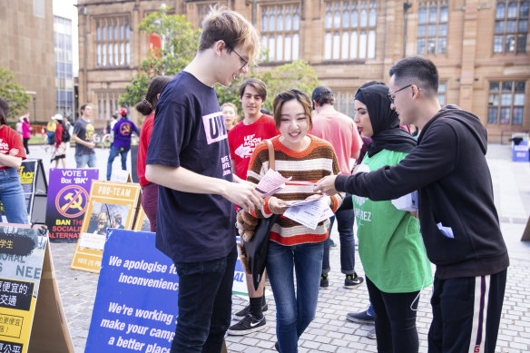 Campaigners contest a voter at student elections at the University of Sydney on September 26. A day earlier, pollsters (not pictured) had asked voters to complete a survey that asked controversial questions about Chinese people.