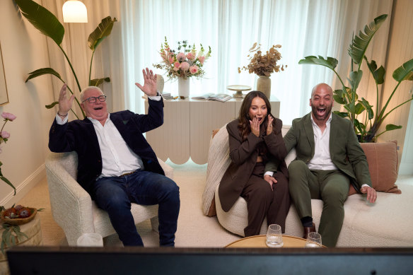Courtney and Grant, with host Scott Cam, react to the winning bid on their home. 