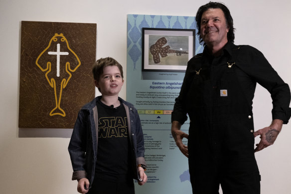 Gryff Nolan, 9, with artist Blak Douglas and their eastern angelshark artworks.