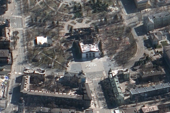 This satellite image provided by Maxar Technologies on Saturday, March 19, 2022 shows the aftermath of the airstrike on the Mariupol Drama theatre, Ukraine, and the word “children” painted on the ground outside the building.