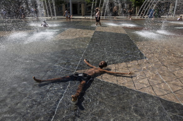 Kais Bothe relaxes in the cool in the city hall pool, as temperatures hit 37 degrees in Edmonton, Alberta, on Wednesday.