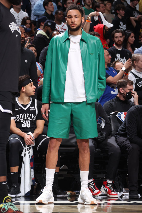 Courtside in matching Prada jacket and shorts. Simmons has been called a “style icon” as well as “looking like Zoolander”.