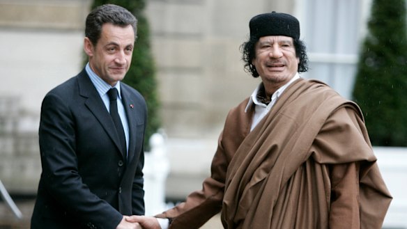 Nicolas Sarkozy, then president of France, greets Libyan leader Moammar Gaddafi in Paris in 2017.