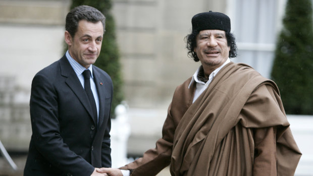 Nicolas Sarkozy, then president, greets Libyan leader Moammar Gaddafi in Paris in 2007.