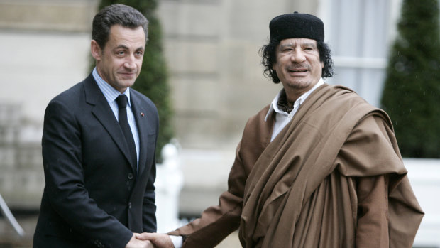 Nicolas Sarkozy, then president of France, greets Libyan leader Moammar Gaddafi in Paris in 2017.