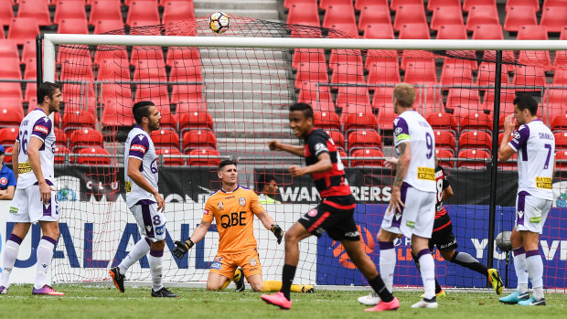 Beaten: Liam Reddy looks on as Mark Bridge's shot opens the scoring for the Wanderers.