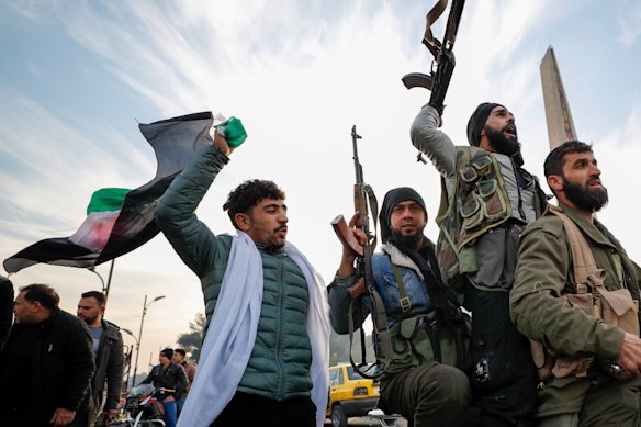 Syrian opposition fighters celebrate after the Syrian government collapsed in Damascus, Syria.