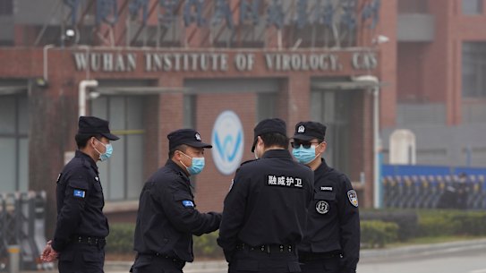 Security personnel gather near the Wuhan Institute of Virology earlier this year.