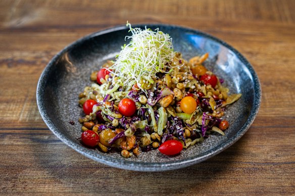 Laphet thoke is a salad made with fermented tea leaves, fried peas, tomatoes and sprouts.