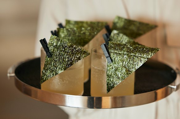 Yuzu sake Japanese spritz with edible nori garnish at Landmark by Lexus.