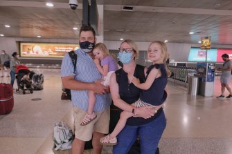 Qantas passengers Jen and Dan, with children Pippa and Tilda, arrive in Melbourne from Queensland on Friday.