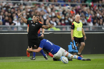 New Zealand’s Sevu Reece, is tackled by Italy’s Michele Lamaro.