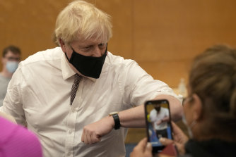 UK Prime Minister Boris Johnson greets members of the public as he visits a COVID-19 vaccination centre in London last week.