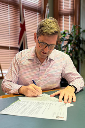 Toowoomba Mayor Geoff McDonald signing off on his council’s submission to GIICA’s 100-day review.