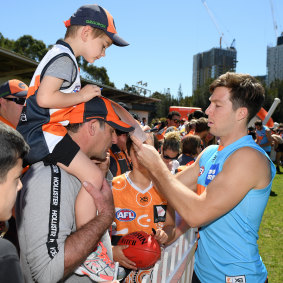 Toby Greene signs an autograph for a young fan on Tuesday.