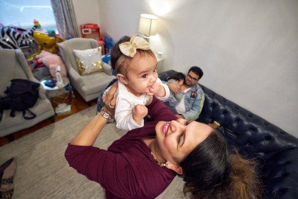 Dheepa Awtani holding five-month-old Deanna with her husband Dixit Awtani and three-year-old Deleena.