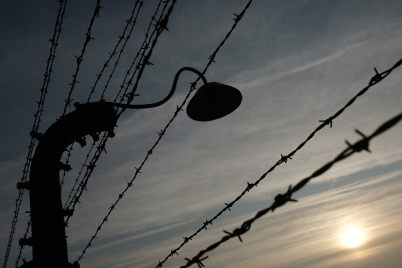 Barbed wire and a floodlight at the former Auschwitz-Birkenau German concentration camp on Sunday, near Oswiecim, Poland, where international leaders and survivors will mark the anniversary of the camp's liberation.
