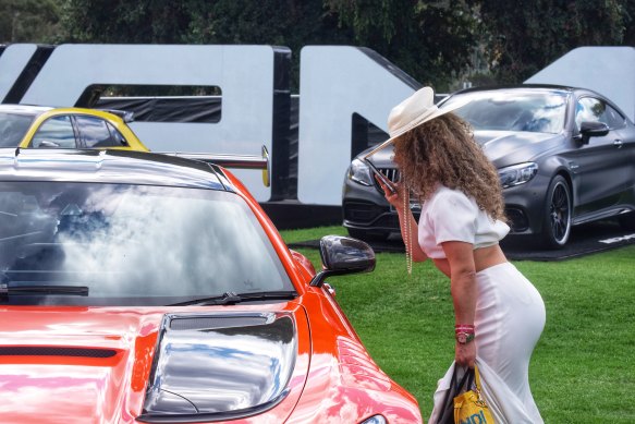 Inspecting the cars at the grand prix. 