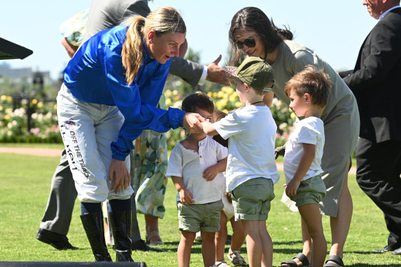 Kah is presented the Dean Holland Trophy by his children.