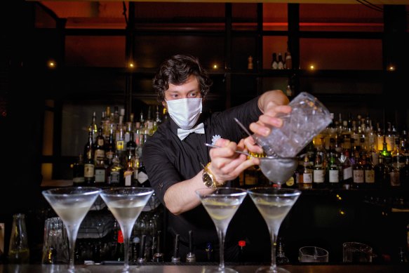 A barman at The Supper Club in the early hours.