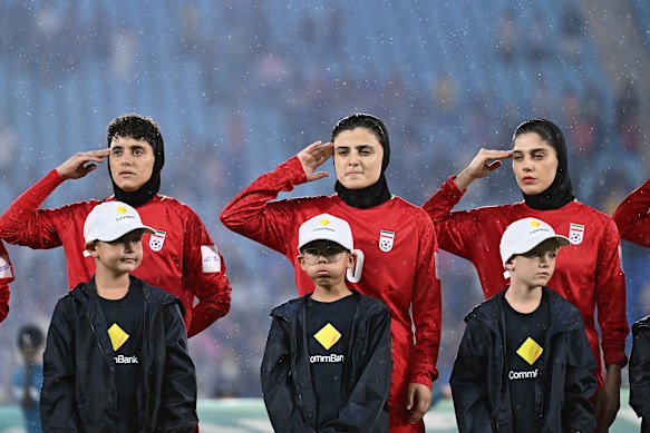 Members of the Iranian women’s soccer team sing the national anthem during the AFC Women’s Asian Cup Australia match against the Philippines on the Gold Coast on March 8.