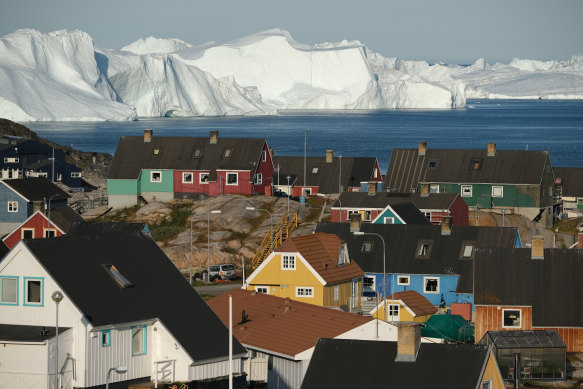 The town of Ilulissat in Greenland, with icebergs looming at the mouth of its fjord.
