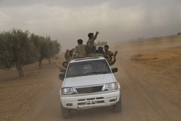 A convoy of Turkish-backed Free Syrian Army troops prepares to cross into Turkey.