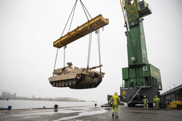 An M1A2 Abrams tank is raised over the pier at the Port of Vlissingen, Netherlands, to be lowered onto a low-barge ship for transportation to another location within Europe in 2019.